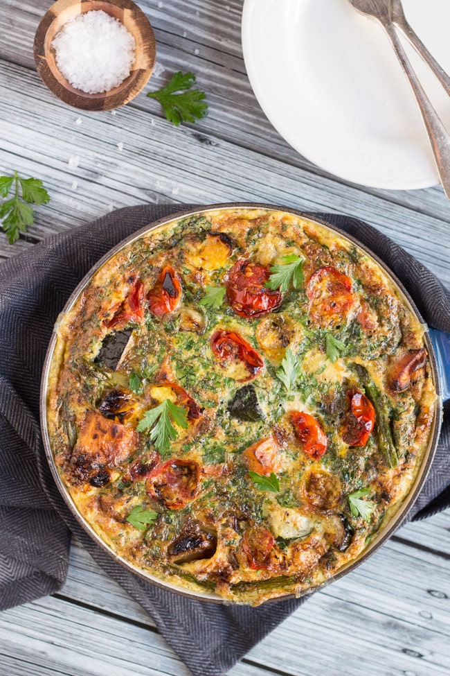 An overhead shot of Leftover Roasted Vegetable Frittata in a blue cast iron frypan. 