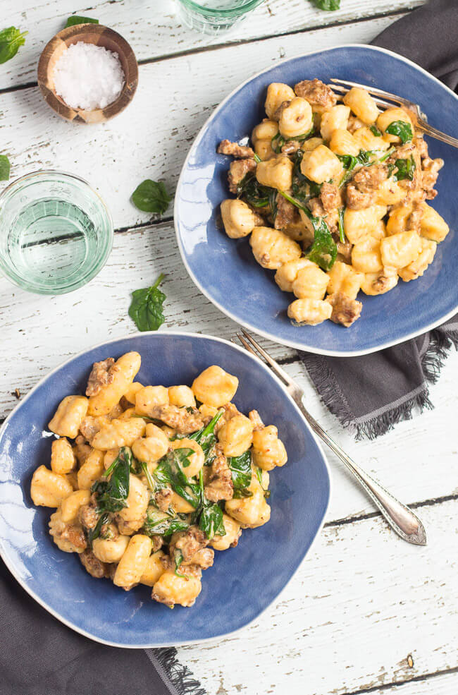 An overhead shot of two plates of a chorizo & spinach easy gnocchi recipe.