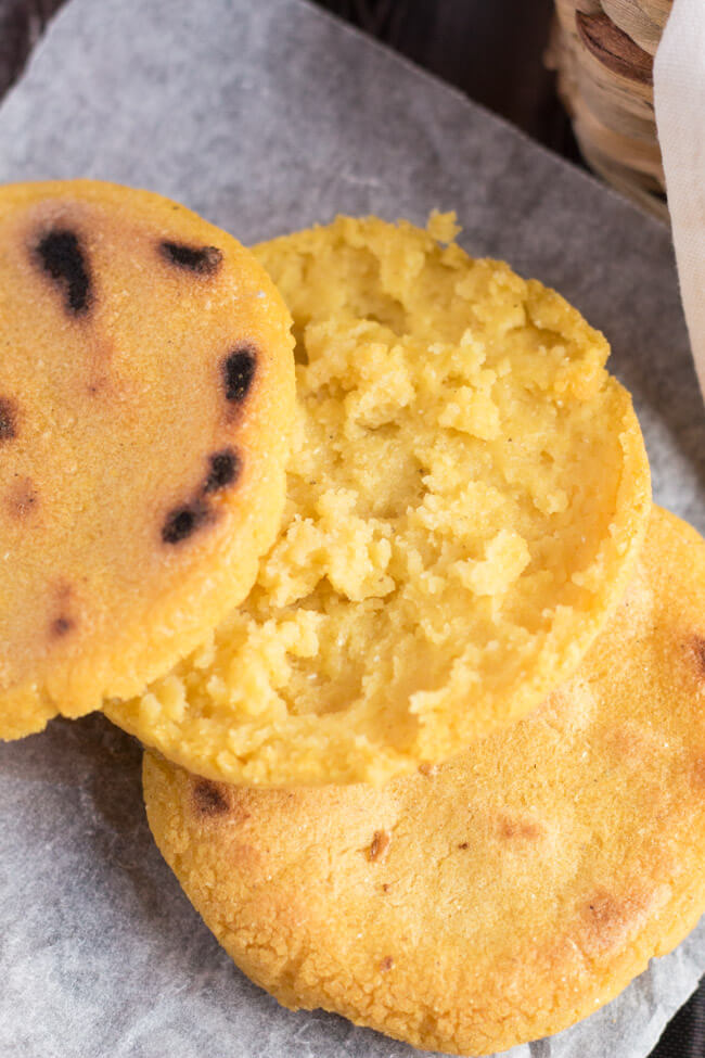 How To Make Arepas: A close up of a split, cooked arepa, showing the internal crumb structure. 