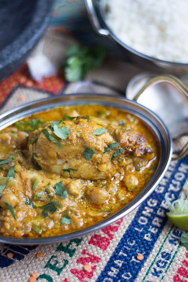 A silver Indian serving dish filled with slow cooker mild chicken curry.