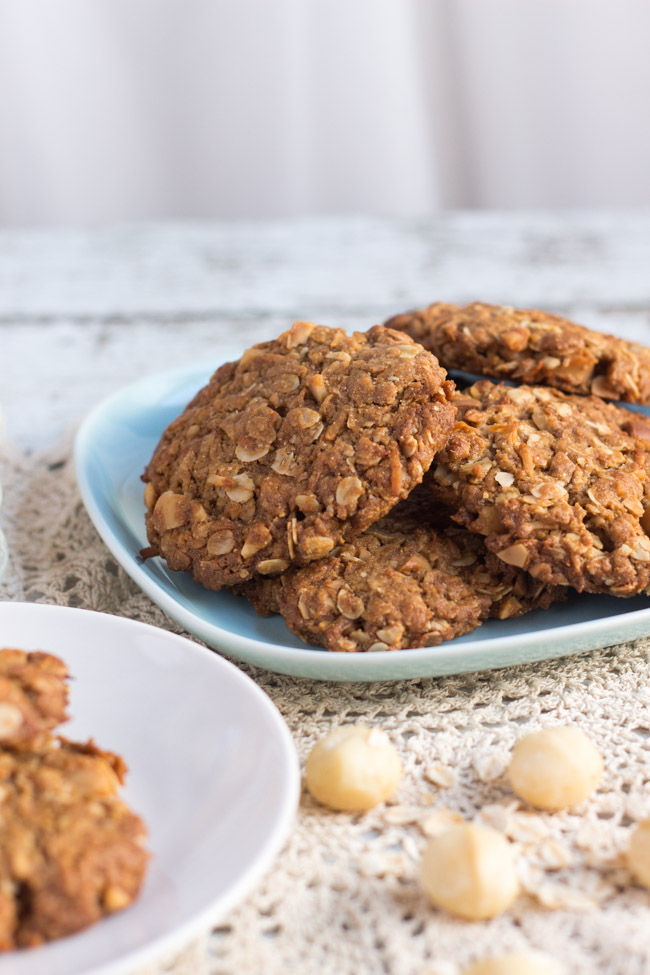 A stack of healthy Anzac biscuits on a square blue plate.  