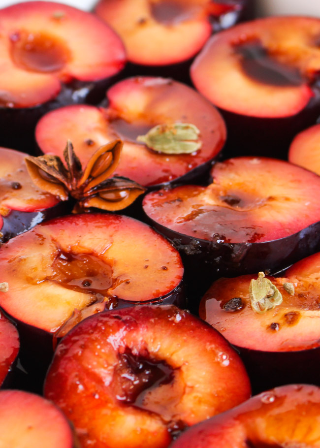 A tray of plum halves prior to baking, which will be turned into spiced plum & yoghurt popsicles. 