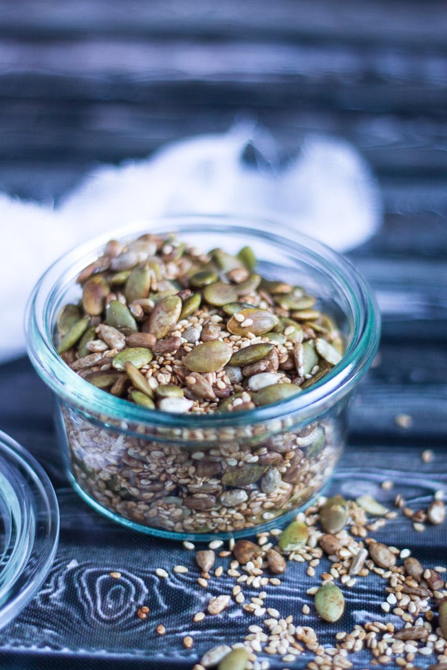 Crunchy salad topping mix, with pumpkin, sunflower and sesame seeds, in a glass jar. 