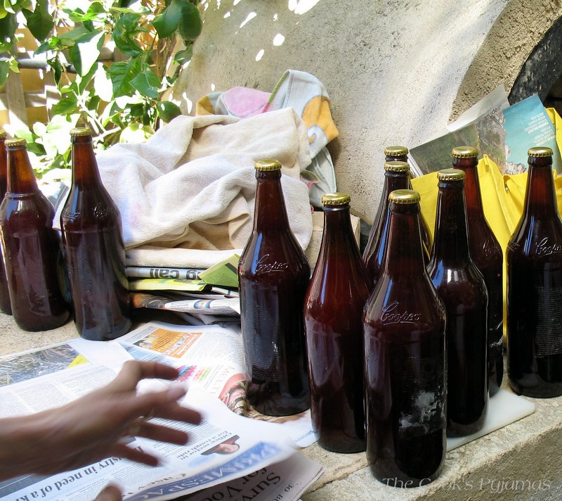 How To Make Tomato Passata: Wrapping the filled bottles in newspaper
