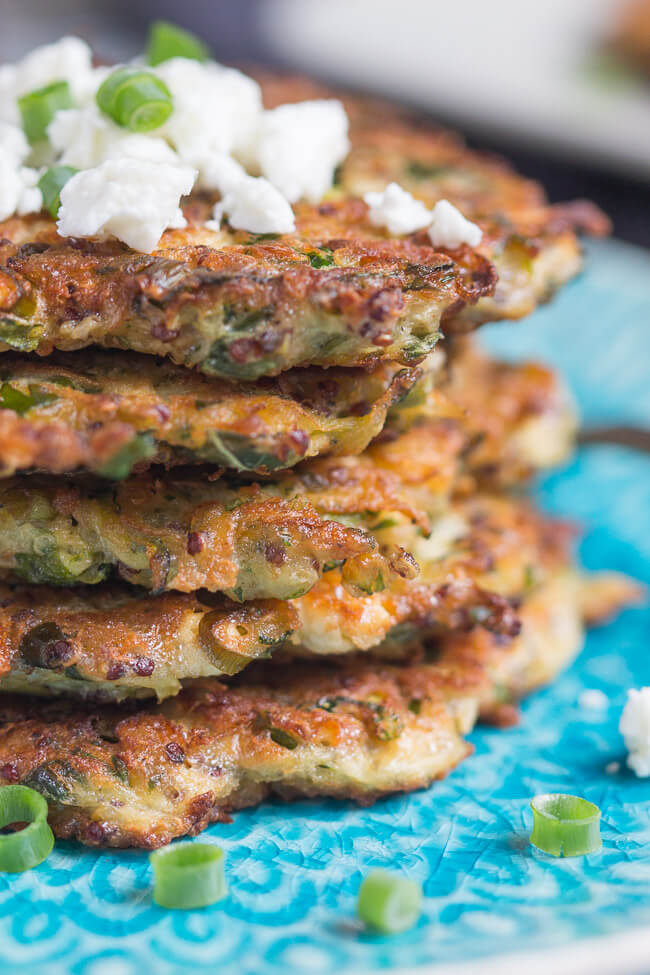 A close up shot of a stack of zucchini & feta fritters, made with leftover quinoa